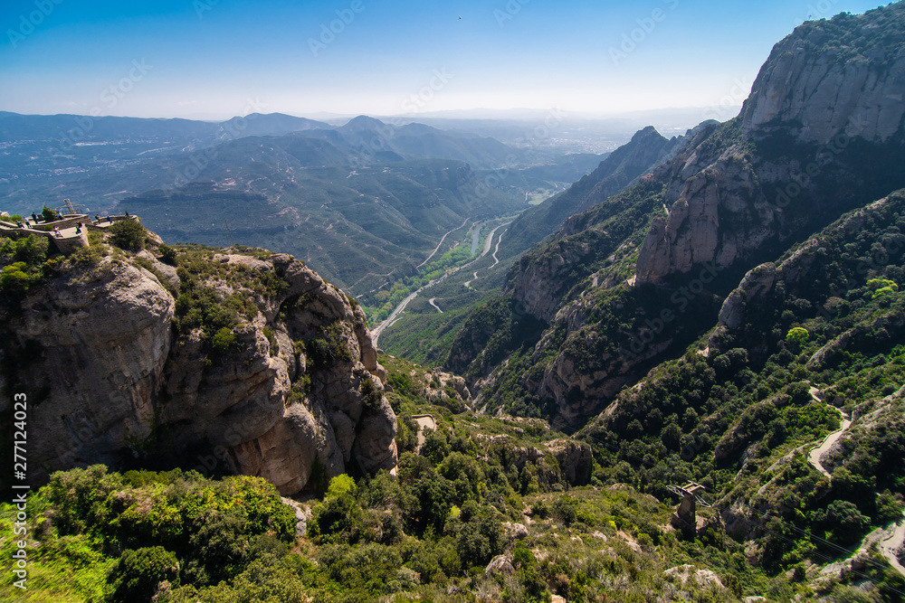 Fototapeta premium Aerial view on Santa Maria de Montserrat Abbey in Montserrat mountains, Spain
