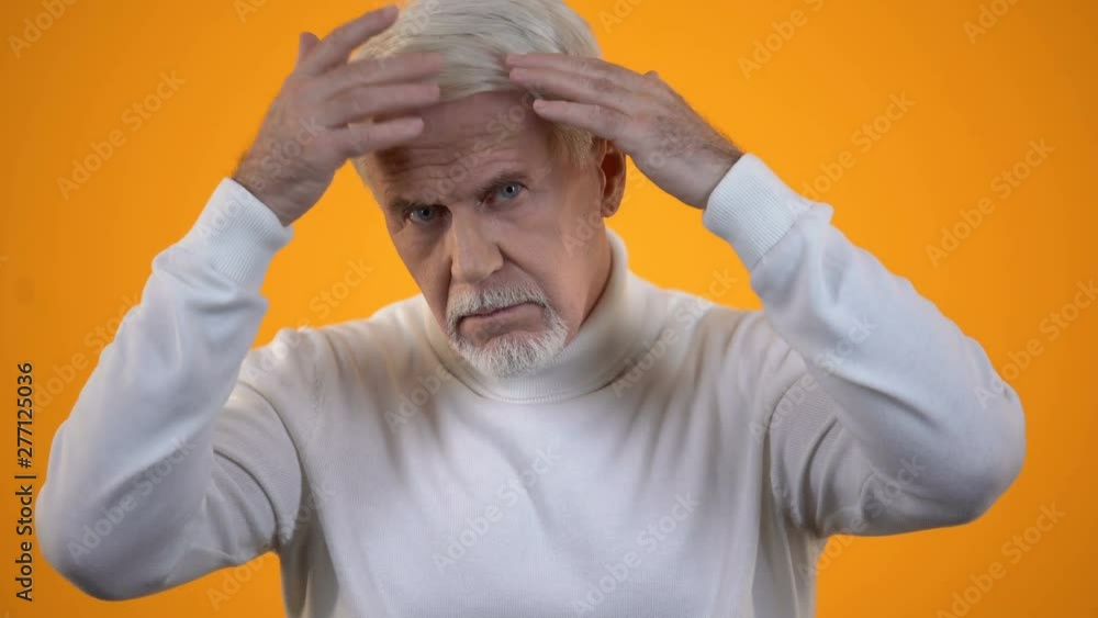 Senior male touching head, upset with hair loss, trichology and health care Senior male touching head, upset with hair loss, trichology and health care