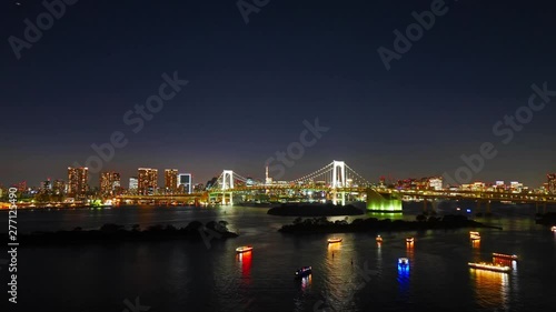 Rainbow bridge in Toyko, Japan. Time lapse of the famous japanese bridge illuminated at night. photo