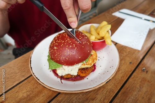 Sweet potato and haloumi burger in a beet bun.