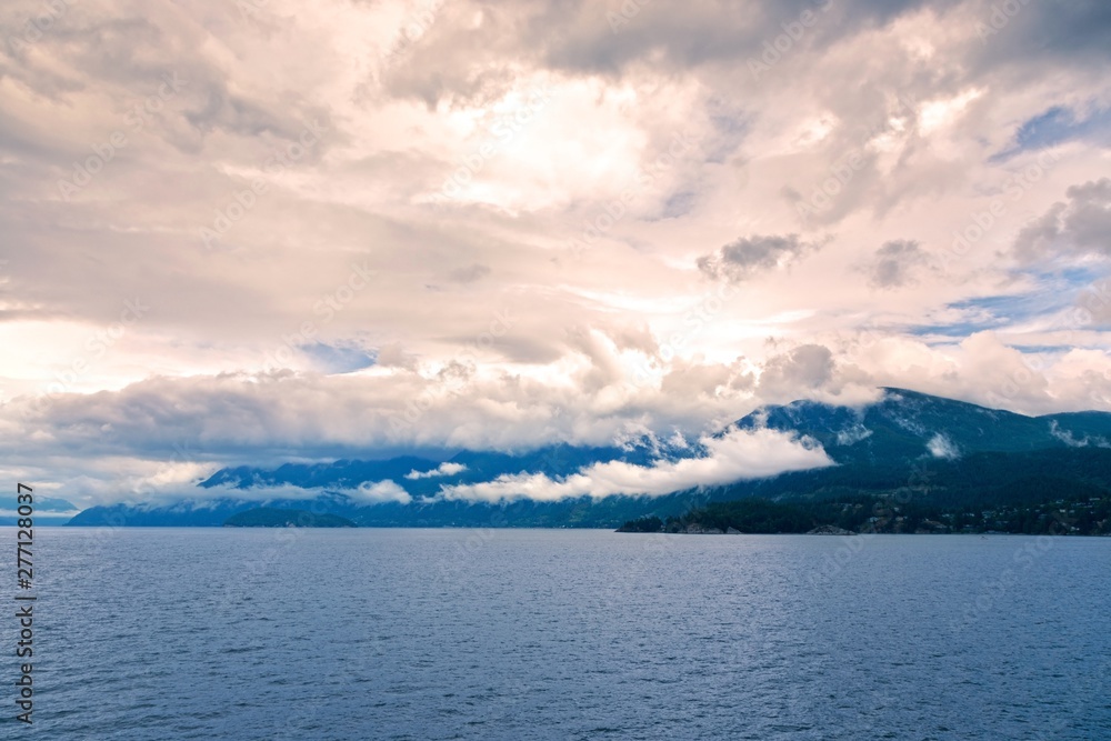 Howe Sound Dramatic Sunset Sky Landscape and Low Clouds over Coast Mountains of British Columbia near Vancouver, Canada Pacific Northwest