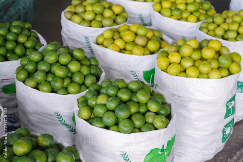 green and yellow limes at a wholesale store