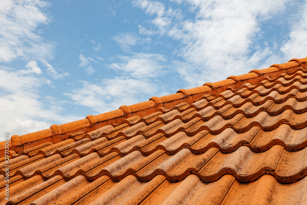 Close up of brown clay roof tiles. Red old dirty roof. Old roof tiles. Construction equipment build a house. Close up of brown clay roof tiles. Red old dirty roof. Old roof tiles. Construction equipment build a house.