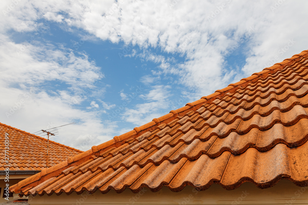 Close up of brown clay roof tiles. Red old dirty roof. Old roof tiles. Construction equipment build a house. Close up of brown clay roof tiles. Red old dirty roof. Old roof tiles. Construction equipment build a house.