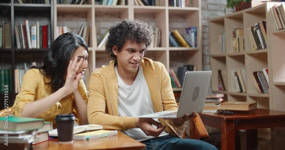 Two cheerful asian students are having a video chat with distant friend or relatives, emotionally talking and discussing something close up 4k Two cheerful asian students are having a video chat with distant friend or relatives, emotionally talking and discussing something close up 4k