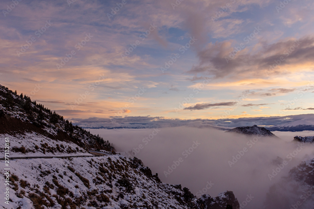 Winter sunset in the Andes mountains with fog in the valley