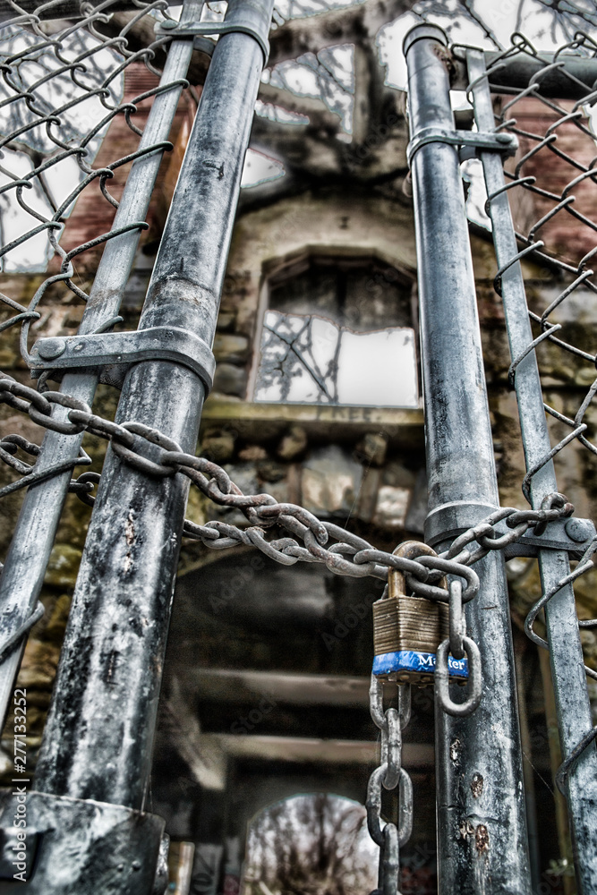 locked up fence to an abandoned house locked up fence to an abandoned house
