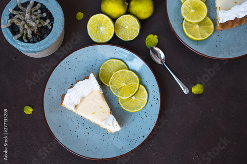 Lemon pie on a plate on brown background