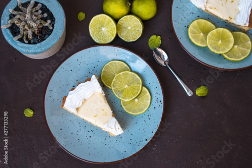 Lemon pie on a plate on brown background