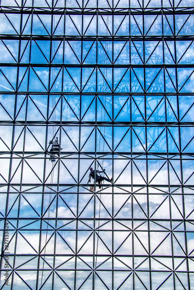 window washers cleaning the windows outside of a building
