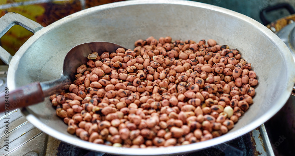 Roasted peanuts in a pan on the stove Roasted peanuts in a pan on the stove