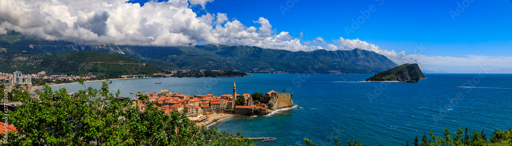 Panoramic view of Budva Old Town with an ancient Citadel and Adriatic Sea with mountains in the background in Montenegro
