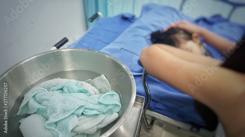 The kid had high fever and need (tepid) sponging to bring the temperature down.