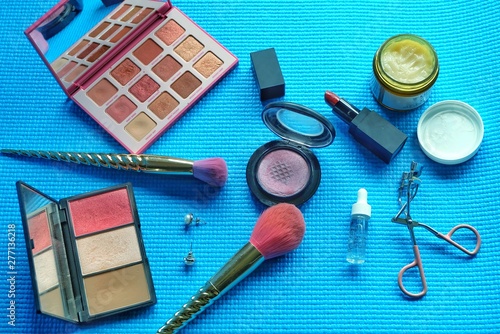 Professional makeup brushes and tools  on green pastel background