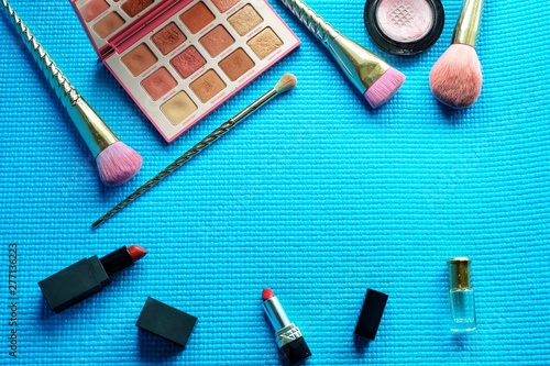 Professional makeup brushes and tools  on green pastel background