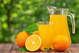 orange juice in glass and jug