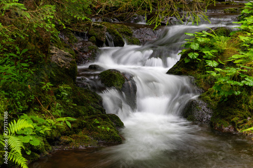 Water cascading over a rocky shelf in a river