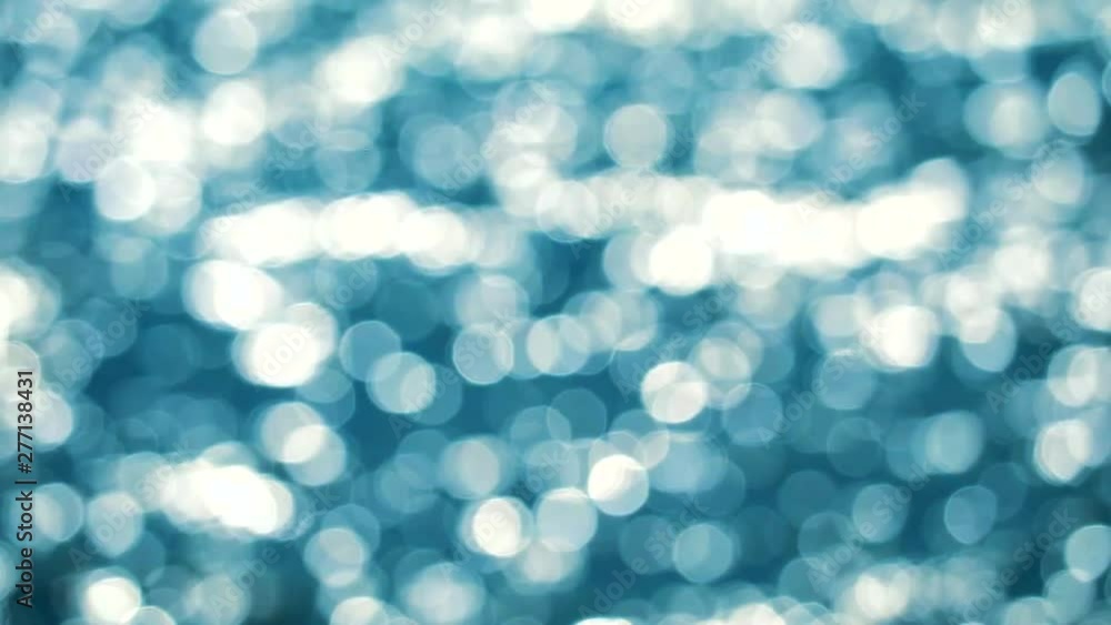 Blurred reflection of wave on sea surface on summer aqua blue and white bokeh blink background1 Blurred reflection of wave on sea surface on summer aqua blue and white bokeh blink background1