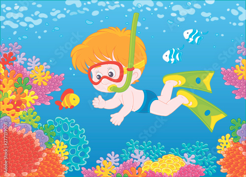 Little boy diving with a mask and a snorkel among funny striped fishes on a colorful coral reef in blue water of a tropical sea  vector illustration in a cartoon style