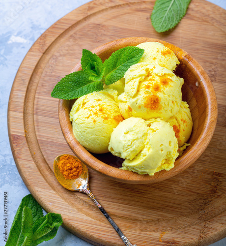 Golden ice cream with turmeric closeup. photo