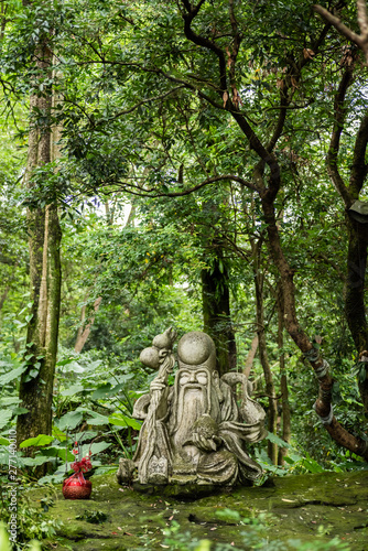 taoism stone statue under a tree