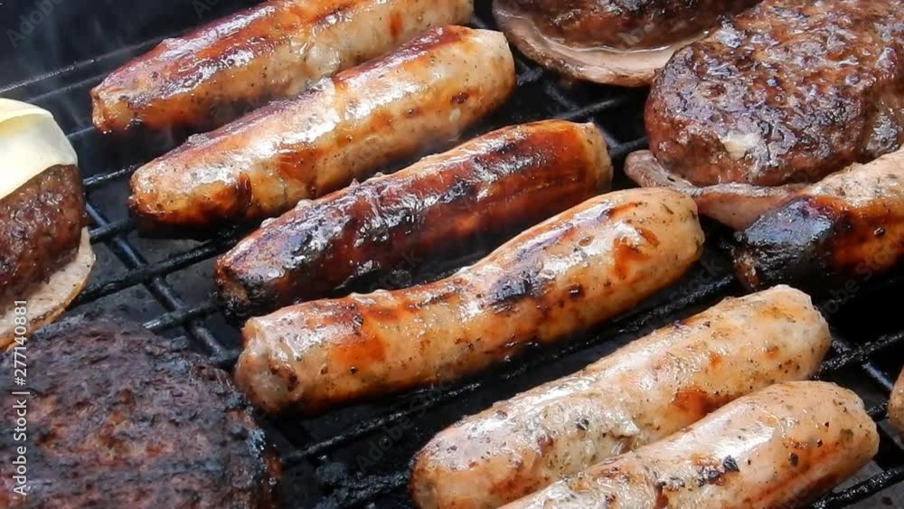 BBQ sausages cooking on outdoor grille, smoke & flames grilling food. BBQ sausages cooking on outdoor grille, smoke & flames grilling food.