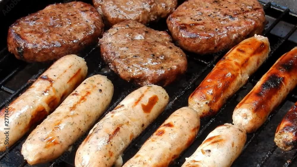 BBQ sausages cooking on outdoor grille, smoke & flames grilling food. BBQ sausages cooking on outdoor grille, smoke & flames grilling food.