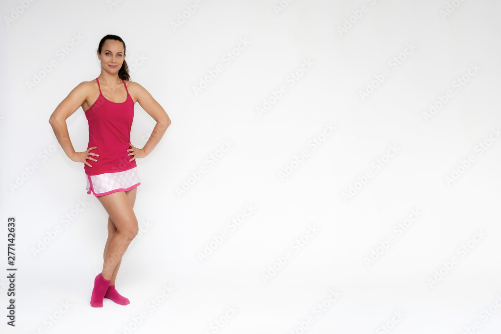 Full-length portrait on white background of beautiful pretty fitness girl woman in pink sport uniform standing exercises in different poses with different emotions. Smiles Stylish trendy youth. Full-length portrait on white background of beautiful pretty fitness girl woman in pink sport uniform standing exercises in different poses with different emotions. Smiles Stylish trendy youth.
