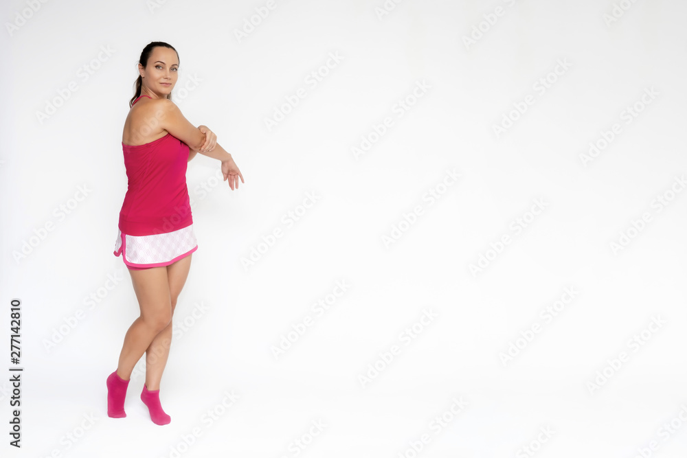 Full-length portrait on white background of beautiful pretty fitness girl woman in pink sport uniform standing exercises in different poses with different emotions. Smiles Stylish trendy youth. Full-length portrait on white background of beautiful pretty fitness girl woman in pink sport uniform standing exercises in different poses with different emotions. Smiles Stylish trendy youth.