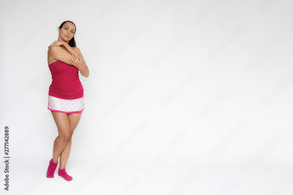 Full-length portrait on white background of beautiful pretty fitness girl woman in pink sport uniform standing exercises in different poses with different emotions. Smiles Stylish trendy youth. Full-length portrait on white background of beautiful pretty fitness girl woman in pink sport uniform standing exercises in different poses with different emotions. Smiles Stylish trendy youth.