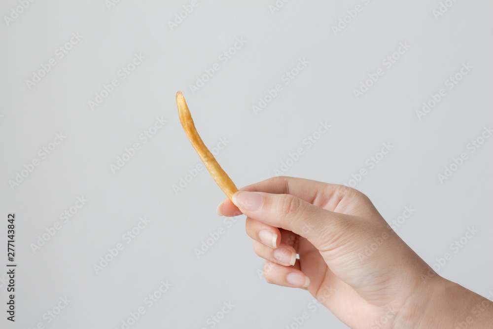 Hand holding french Fries on white background. Hand holding french Fries on white background.