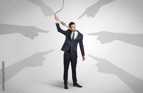 Young businessman trying to suicide with pointing hands concept photo