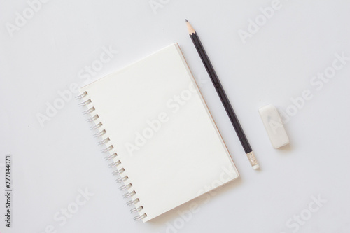 Top view of blank notebook with pencil and eraser on with background. Education concept.