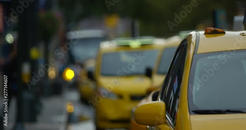 Iconic Yellow New York Taxi Shutting Door Picking Up Passengers  and Driving Into the Famous Manhattan NYC On Iconic New York Side Walk