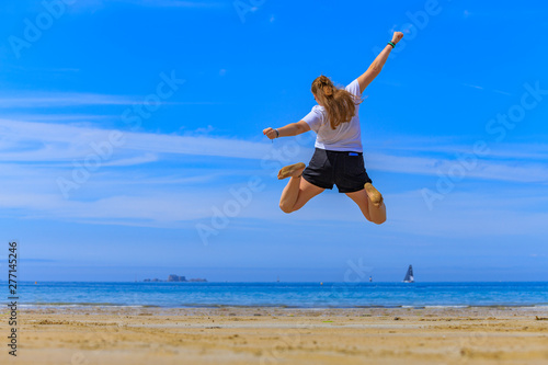 girl jumping on the beach