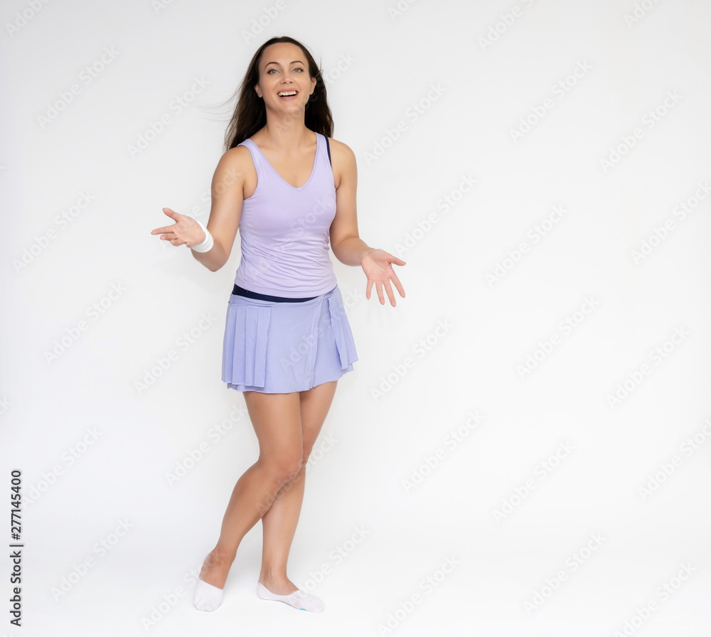 Full-length portrait on white background of beautiful pretty fitness girl woman in trendy tennis sport uniform, with different emotions in different poses, shows hands. Smiles. Stylish trendy youth. Full-length portrait on white background of beautiful pretty fitness girl woman in trendy tennis sport uniform, with different emotions in different poses, shows hands. Smiles. Stylish trendy youth.