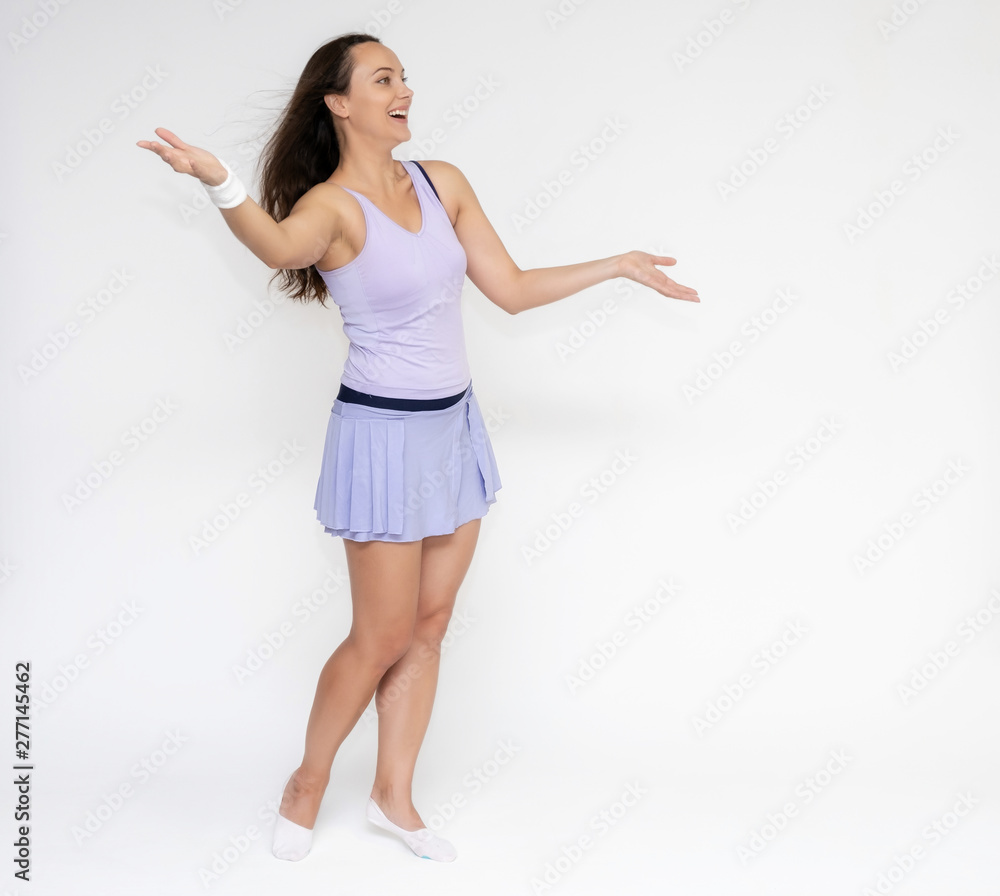 Full-length portrait on white background of beautiful pretty fitness girl woman in trendy tennis sport uniform, with different emotions in different poses, shows hands. Smiles. Stylish trendy youth. Full-length portrait on white background of beautiful pretty fitness girl woman in trendy tennis sport uniform, with different emotions in different poses, shows hands. Smiles. Stylish trendy youth.