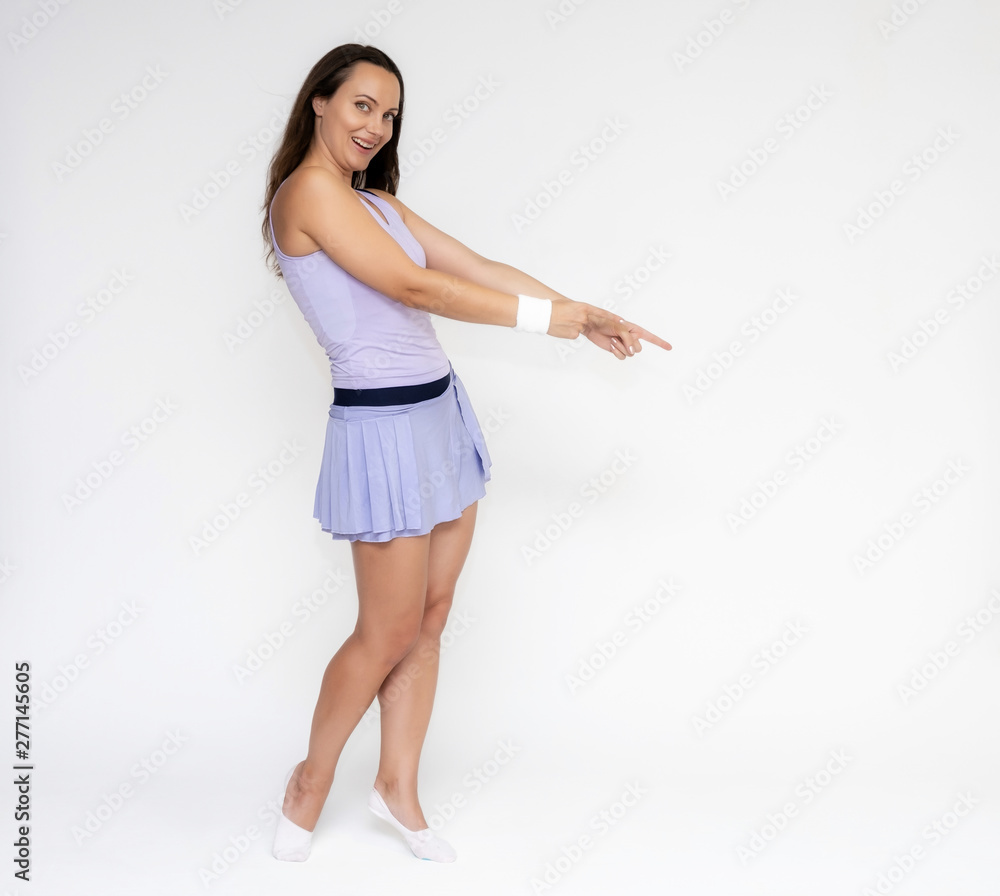 Full-length portrait on white background of beautiful pretty fitness girl woman in trendy tennis sport uniform, with different emotions in different poses, shows hands. Smiles. Stylish trendy youth. Full-length portrait on white background of beautiful pretty fitness girl woman in trendy tennis sport uniform, with different emotions in different poses, shows hands. Smiles. Stylish trendy youth.