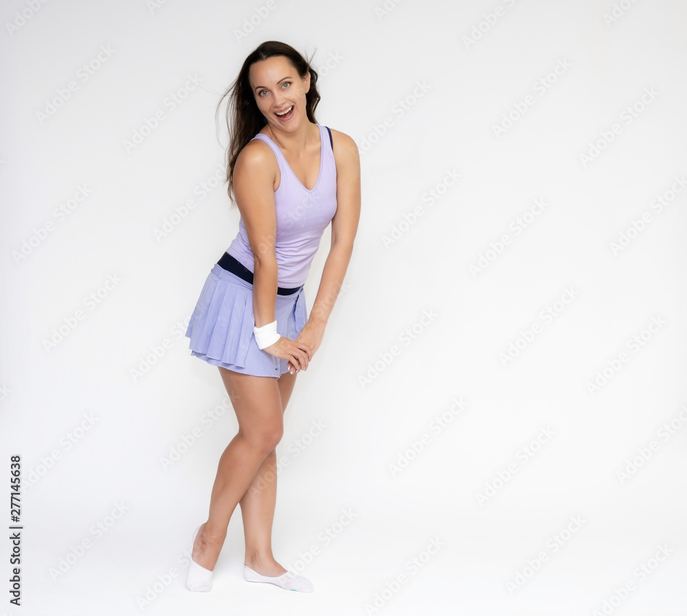 Full-length portrait on white background of beautiful pretty fitness girl woman in trendy tennis sport uniform, with different emotions in different poses, shows hands. Smiles. Stylish trendy youth. Full-length portrait on white background of beautiful pretty fitness girl woman in trendy tennis sport uniform, with different emotions in different poses, shows hands. Smiles. Stylish trendy youth.