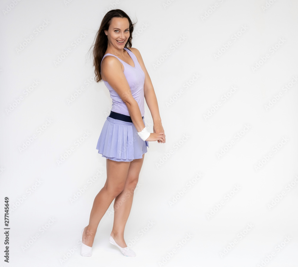 Full-length portrait on white background of beautiful pretty fitness girl woman in trendy tennis sport uniform, with different emotions in different poses, shows hands. Smiles. Stylish trendy youth. Full-length portrait on white background of beautiful pretty fitness girl woman in trendy tennis sport uniform, with different emotions in different poses, shows hands. Smiles. Stylish trendy youth.