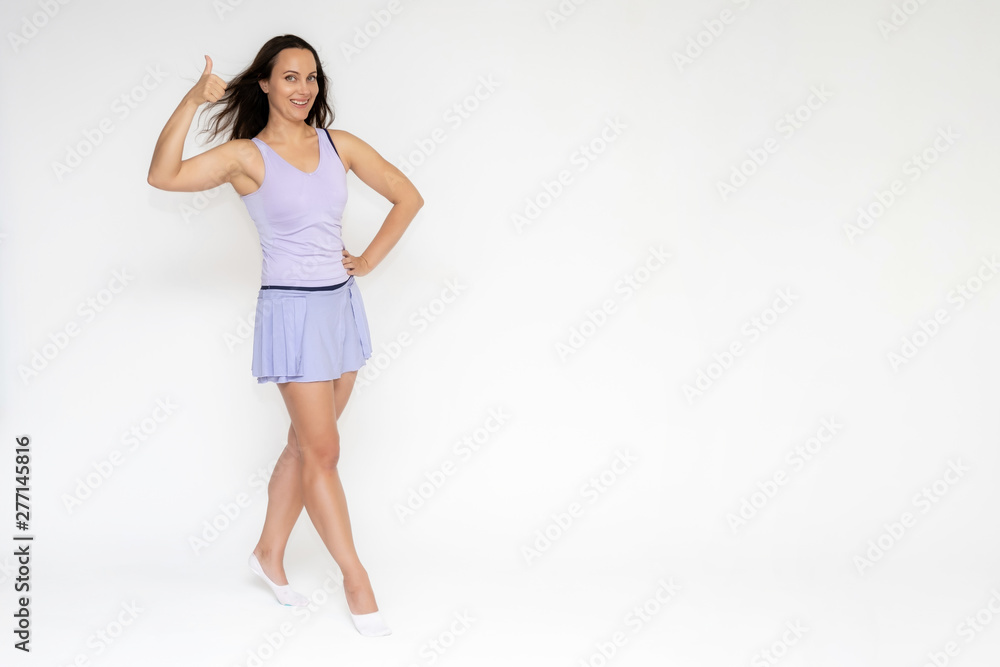 Full-length portrait on white background of beautiful pretty fitness girl woman in trendy tennis sport uniform, with different emotions in different poses, shows hands. Smiles. Stylish trendy youth. Full-length portrait on white background of beautiful pretty fitness girl woman in trendy tennis sport uniform, with different emotions in different poses, shows hands. Smiles. Stylish trendy youth.