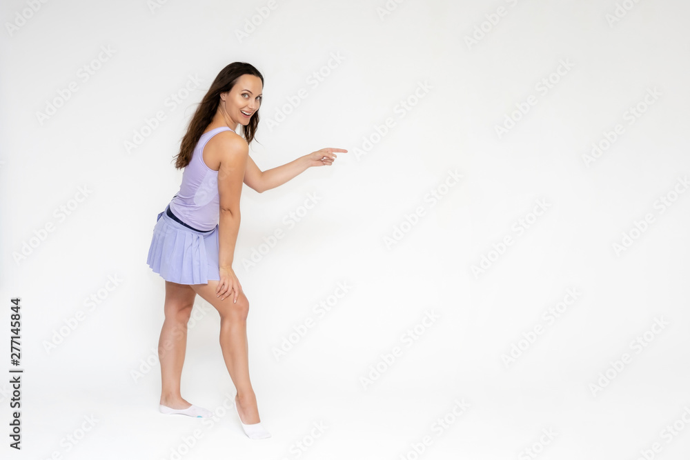 Full-length portrait on white background of beautiful pretty fitness girl woman in trendy tennis sport uniform, with different emotions in different poses, shows hands. Smiles. Stylish trendy youth. Full-length portrait on white background of beautiful pretty fitness girl woman in trendy tennis sport uniform, with different emotions in different poses, shows hands. Smiles. Stylish trendy youth.
