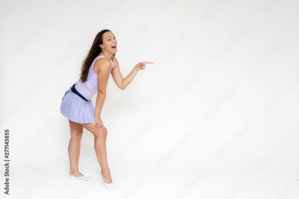 Full-length portrait on white background of beautiful pretty fitness girl woman in trendy tennis sport uniform, with different emotions in different poses, shows hands. Smiles. Stylish trendy youth. Full-length portrait on white background of beautiful pretty fitness girl woman in trendy tennis sport uniform, with different emotions in different poses, shows hands. Smiles. Stylish trendy youth.