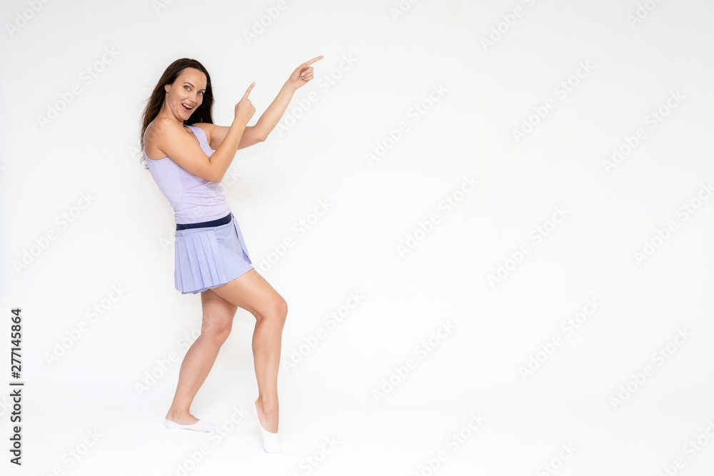 Full-length portrait on white background of beautiful pretty fitness girl woman in trendy tennis sport uniform, with different emotions in different poses, shows hands. Smiles. Stylish trendy youth. Full-length portrait on white background of beautiful pretty fitness girl woman in trendy tennis sport uniform, with different emotions in different poses, shows hands. Smiles. Stylish trendy youth.