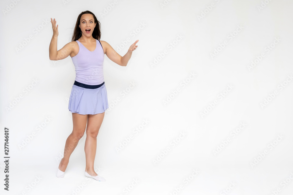 Full-length portrait on white background of beautiful pretty fitness girl woman in trendy tennis sport uniform, with different emotions in different poses, shows hands. Smiles. Stylish trendy youth. Full-length portrait on white background of beautiful pretty fitness girl woman in trendy tennis sport uniform, with different emotions in different poses, shows hands. Smiles. Stylish trendy youth.