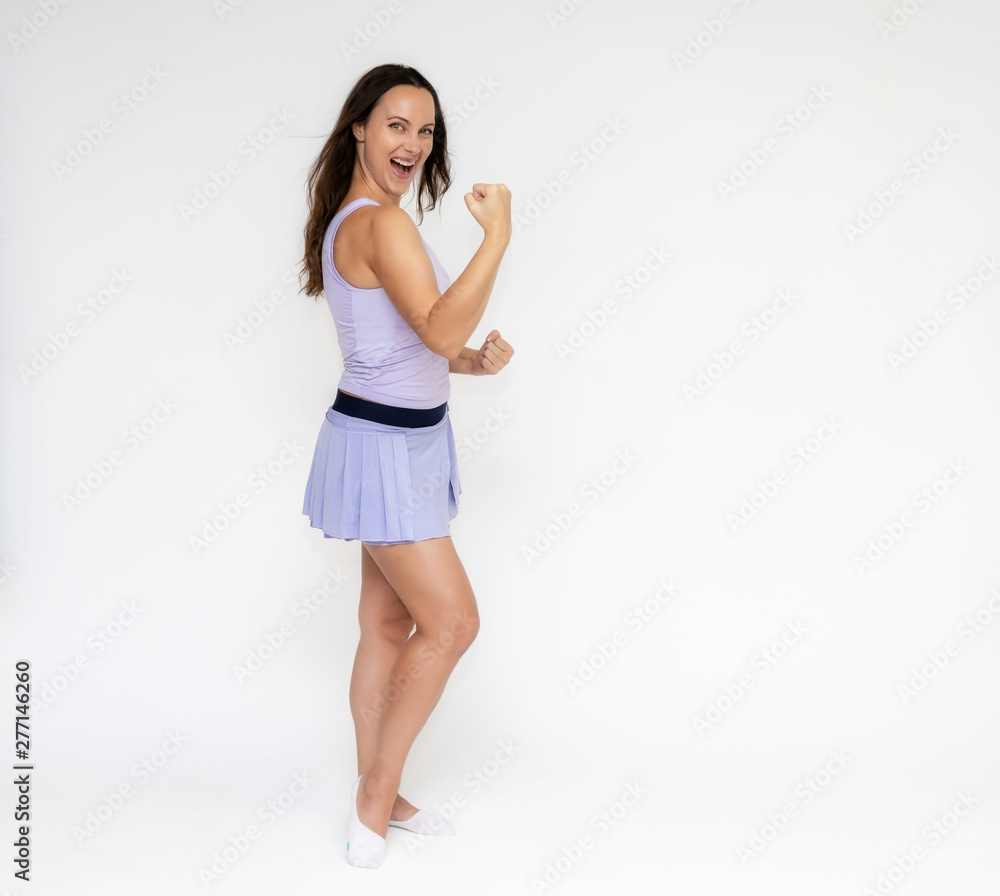 Fototapeta premium Full-length portrait on white background of beautiful pretty fitness girl woman in trendy tennis sport uniform, with different emotions in different poses, shows hands. Smiles. Stylish trendy youth.