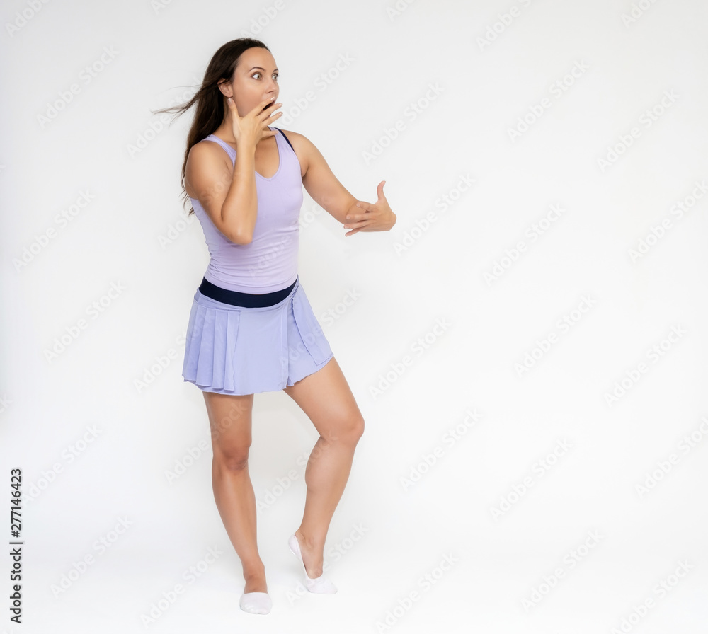 Full-length portrait on white background of beautiful pretty fitness girl woman in trendy tennis sport uniform, with different emotions in different poses, shows hands. Smiles. Stylish trendy youth. Full-length portrait on white background of beautiful pretty fitness girl woman in trendy tennis sport uniform, with different emotions in different poses, shows hands. Smiles. Stylish trendy youth.