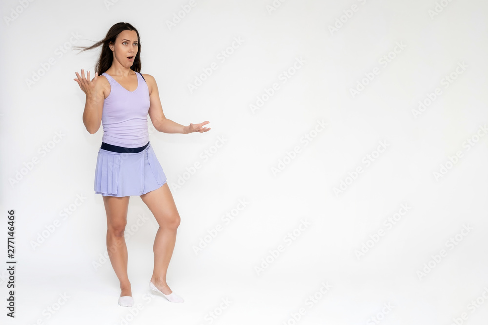 Full-length portrait on white background of beautiful pretty fitness girl woman in trendy tennis sport uniform, with different emotions in different poses, shows hands. Smiles. Stylish trendy youth. Full-length portrait on white background of beautiful pretty fitness girl woman in trendy tennis sport uniform, with different emotions in different poses, shows hands. Smiles. Stylish trendy youth.