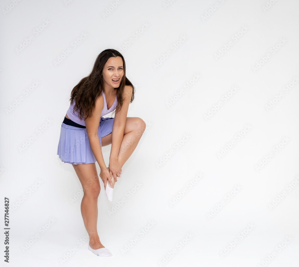 Full-length portrait on white background of beautiful pretty fitness girl woman in fashionable tennis sportswear, experiencing pain, injury in various poses, shows hands. Smiles Stylish trendy youth. Full-length portrait on white background of beautiful pretty fitness girl woman in fashionable tennis sportswear, experiencing pain, injury in various poses, shows hands. Smiles Stylish trendy youth.
