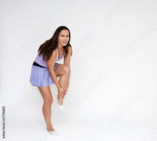 Full-length portrait on white background of beautiful pretty fitness girl woman in fashionable tennis sportswear, experiencing pain, injury in various poses, shows hands. Smiles Stylish trendy youth. © Вячеслав Чичаев